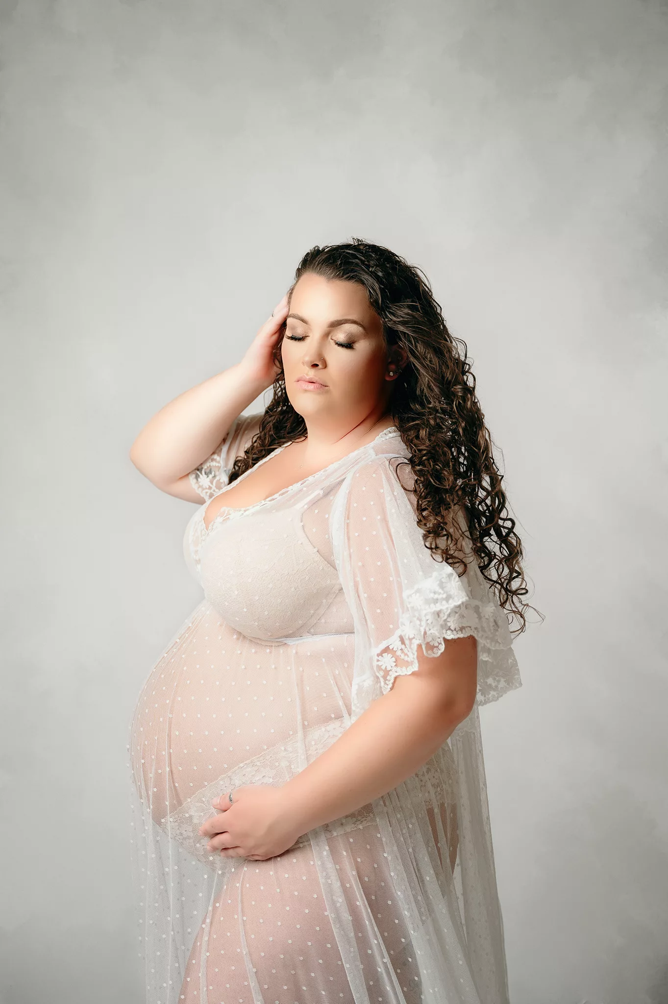 elegant maternity photoshoot with sheer white dress