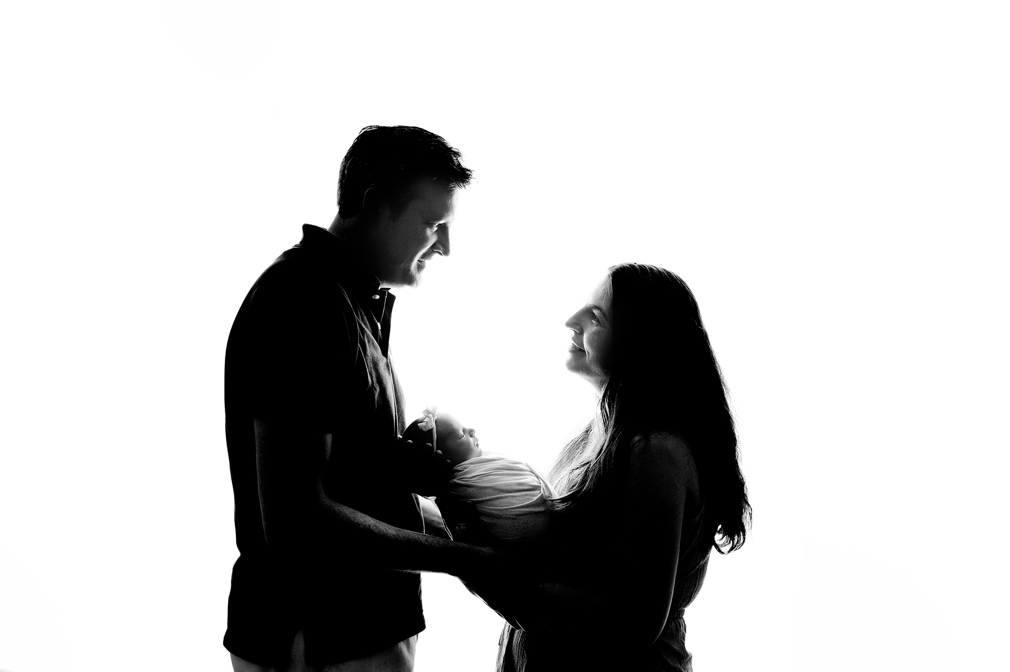 silhouette newborn photo with parents
