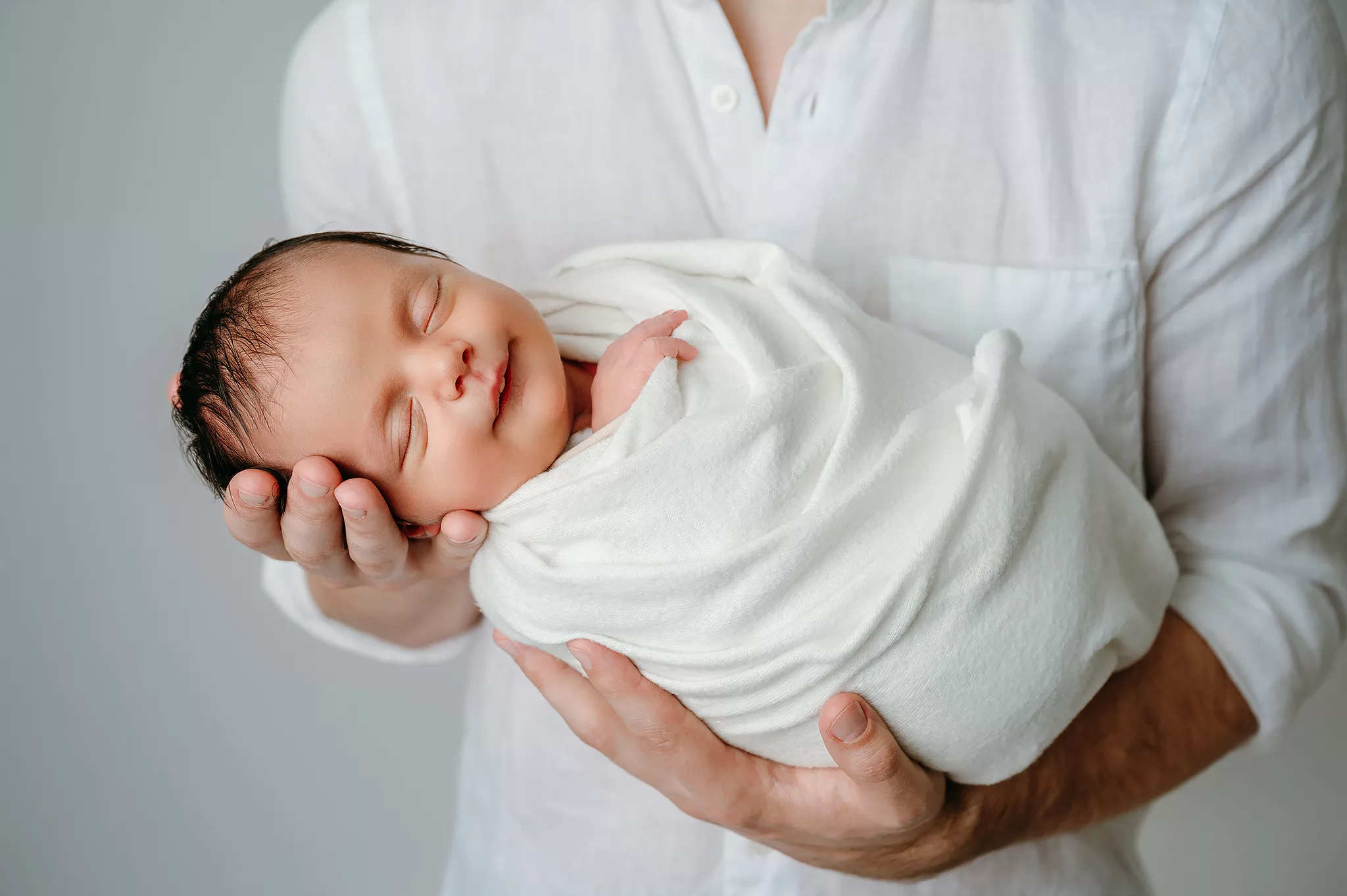studio newborn photoshoot with parent