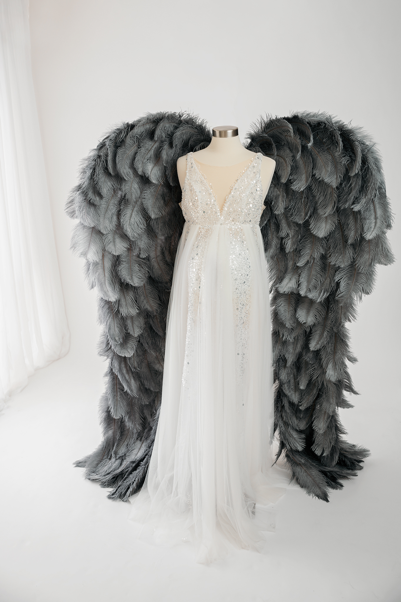 white pregnancy gown with angel wings for photoshoot